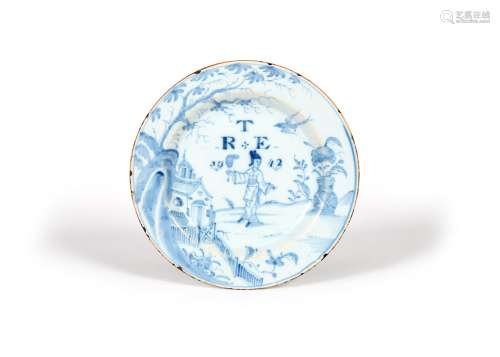 A delftware plate, dated 1742, probably London, painted in blue with a Chinese lady holding a fan