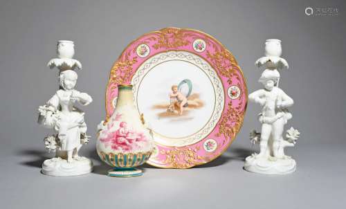 A pair of Minton candlestick figures, 19th century, modelled as a boy and girl as gardeners, left in