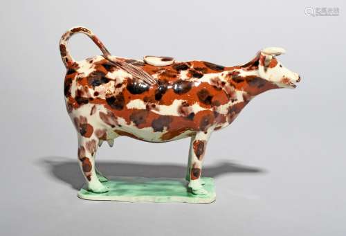 A Staffordshire pearlware cow creamer and cover, late 18th/early 19th century, standing four
