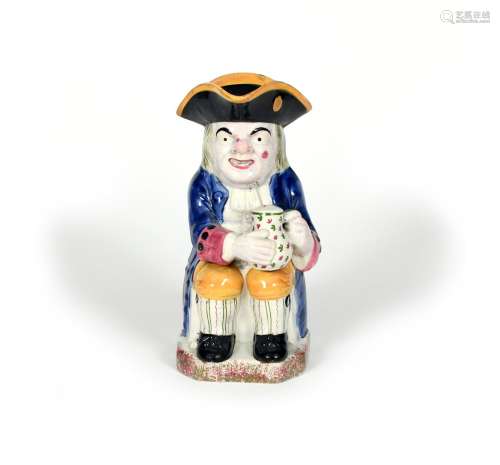 An Ordinary Toby jug, c.1820, typically modelled with a foaming jug of ale, decorated in