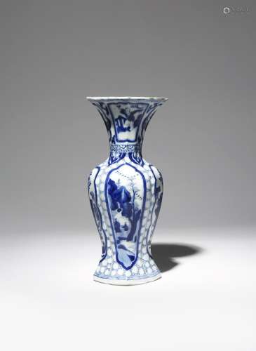 A CHINESE BLUE AND WHITE MOULDED VASE KANGXI 1662-1722 Painted with panels enclosing figures in