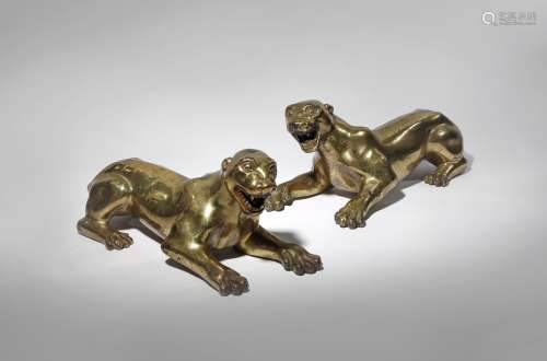 A PAIR OF GILT-BRONZE MODELS OF LEOPARDS 19TH/20TH CENTURY Possibly Tibetan, the stocky felines