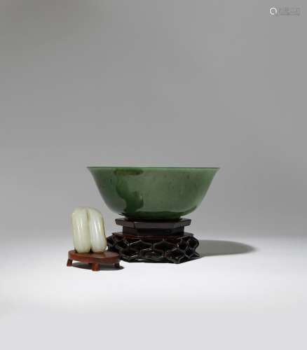A CHINESE SPINACH-GREEN JADE BOWL AND A PALE CELADON JADE 'BITTER MELON' CARVING 18TH CENTURY The