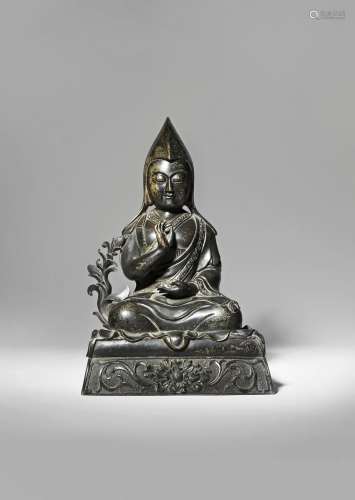 A TIBETAN BRONZE FIGURE OF A LAMA OF THE GELUKPA ORDER QING DYNASTY Cast seated in dhyanasana upon