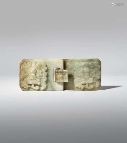 A CHINESE CELADON JADE BELT BUCKLE 18TH/19TH CENTURY Each of the two sections carved in relief