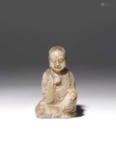 A CHINESE SOAPSTONE SEATED FIGURE QING DYNASTY OR LATER Depicted with his right hand at his chest
