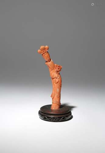 A CHINESE CORAL CARVING OF A LADY 19TH CENTURY The slender figure stands dressed in long robes