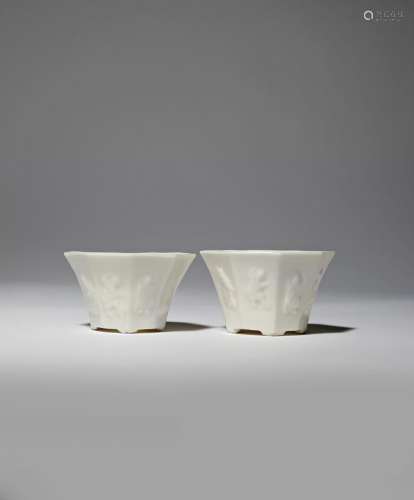 A NEAR PAIR OF CHINESE BLANC DE CHINE 'BAXIAN' WINE CUPS 18TH CENTURY Each with a flared body
