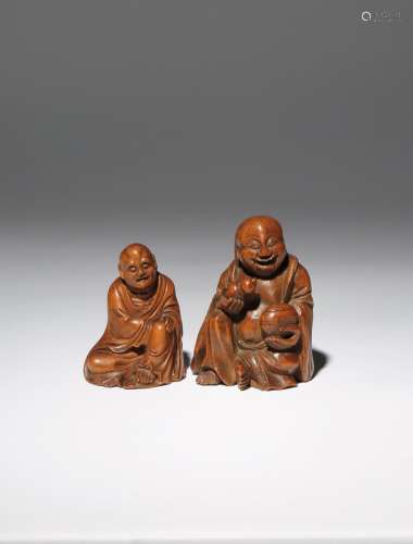 TWO CHINESE BAMBOO SEATED FIGURES QING DYNASTY One carved as one of the Hehe Erxian, he smiles