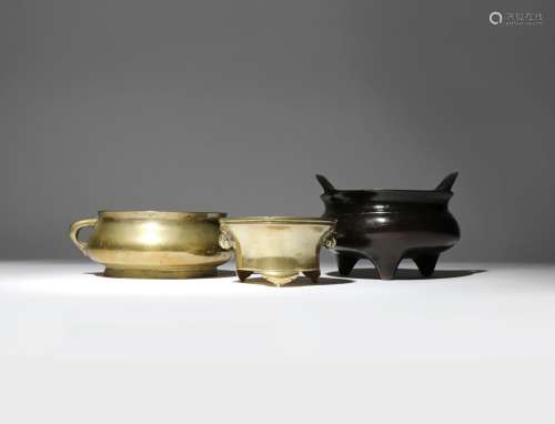 THREE CHINESE BRONZE INCENSE BURNERS QING DYNASTY One with a bombé-shaped body and two loop handles,