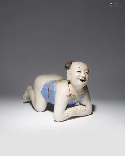 A LARGE CHINESE FAMILLE ROSE PILLOW MODELLED AS A BOY QING DYNASTY OR LATER The child depicted