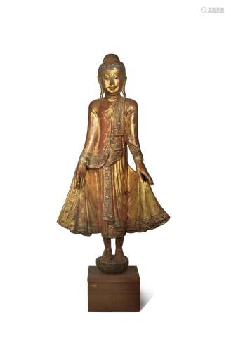 A BURMESE MANDALAY-STYLE LACQUERED AND GILT-WOOD FIGURE OF BUDDHA 19TH CENTURY Standing in