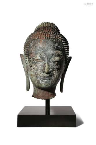 A THAI BRONZE HEAD OF BUDDHA 17TH CENTURY Cast with a serene expression, the face framed by his