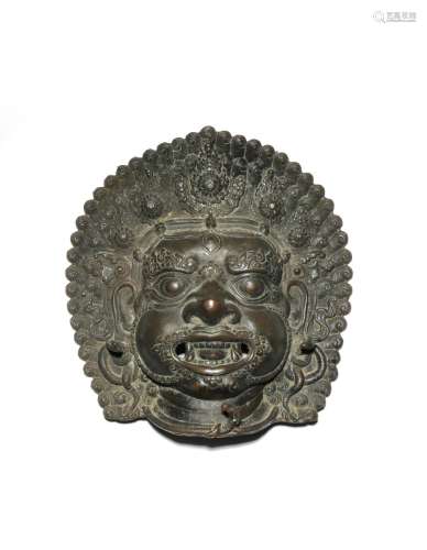 A LARGE INDIAN BRONZE MASK OF BHAIRAVA 18TH CENTURY The fierce manifestation of Shiva with his mouth