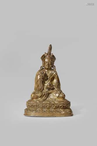 A TIBETAN BRONZE FIGURE OF PADMASAMBHAVA 16TH CENTURY Sitting on a double lotus throne, wearing