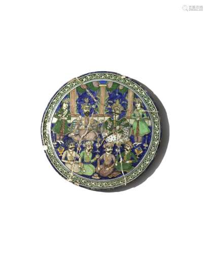A LARGE QAJAR POLYCHROME MOULDED CIRCULAR TILE 19TH CENTURY Painted in green, blue, aubergine, black