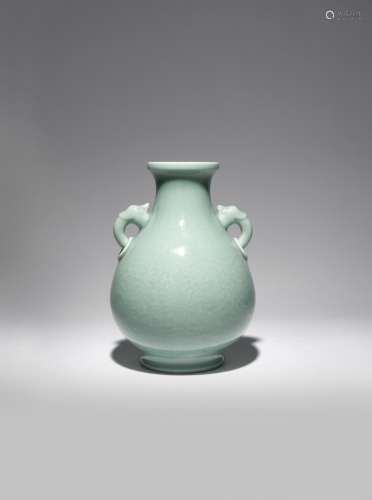 A CHINESE CELADON GLAZED PEAR-SHAPED VASE QING DYNASTY The exterior carved with large stylised lotus