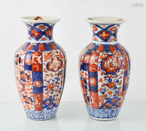 A pair of 19th century Chinese vases, in blue, red and white, 21cm high.