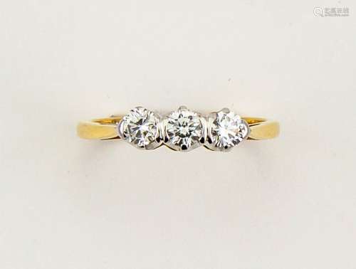 An 18ct yellow gold three stone diamond trilogy ring, size L, 2.8g.