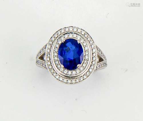 An 18ct white gold, sapphire and diamond ring, the oval cut 2ct sapphire bordered by two rows of