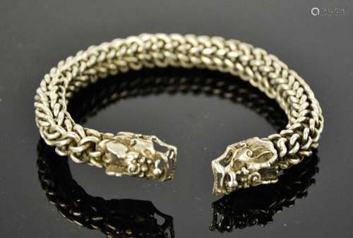 A Tibetan Miao silver dragon bangle, linked body 66g. 8cm wide