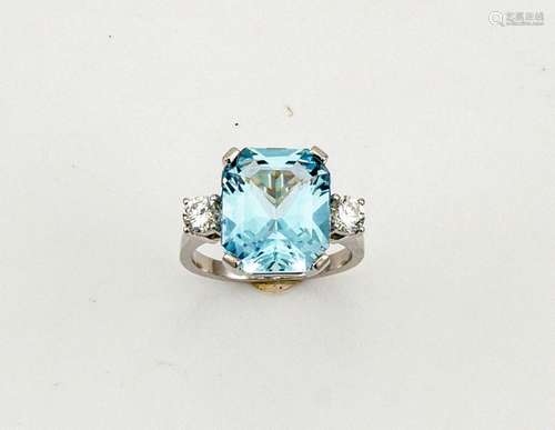 A platinum, aquamarine and diamond ring, the emerald cut aquamarine 7.42ct, flanked by two