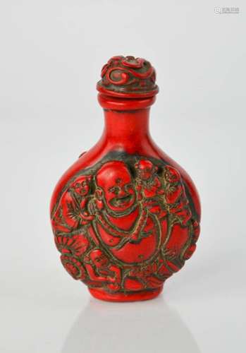 A Chinese handcarved coral colour snuff bottle, having Buddha design