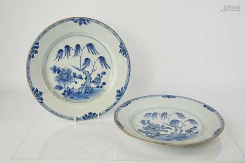 A pair of 19th century Chinese blue and white shallow dishes, depicting willow trees and peonies,