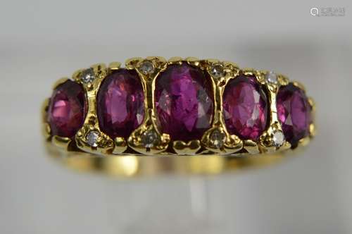 An 18ct gold, ruby and diamond ring, set with five graduated rubies, the largest measuring 5mm long,