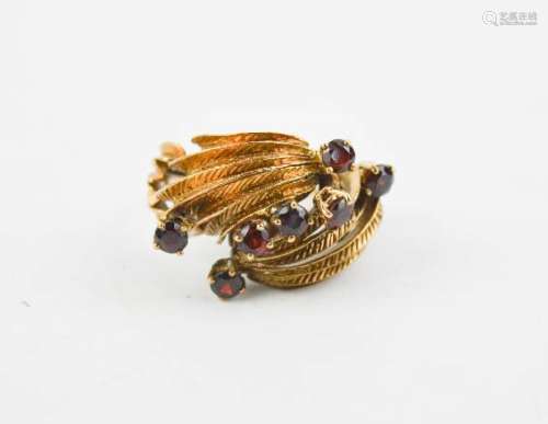 A gold (unmarked) dress ring, set with red paste stones.