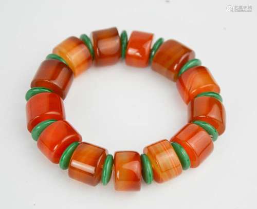 A vintage amber and natural green jade elasticated bracelet