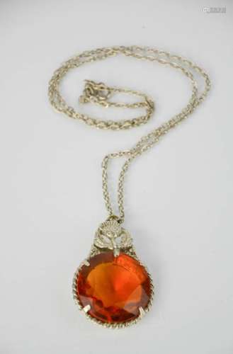 A vintage Scottish large Cairngorm style pendant, amber glass inset