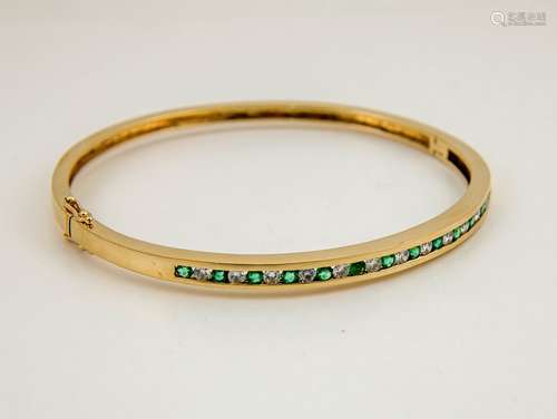 A 14ct gold, diamond and emerald bangle, the thirteen brilliant cut emeralds, interspersed with