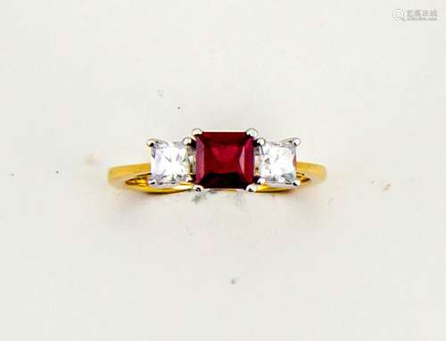 An 18ct yellow gold, ruby and diamond trilogy ring, the ruby approx 0.80ct, and the princess cut