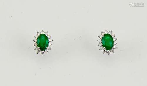 A pair of 18ct white gold, emerald and diamond earrings, the oval cut emeralds approx 0.70cts