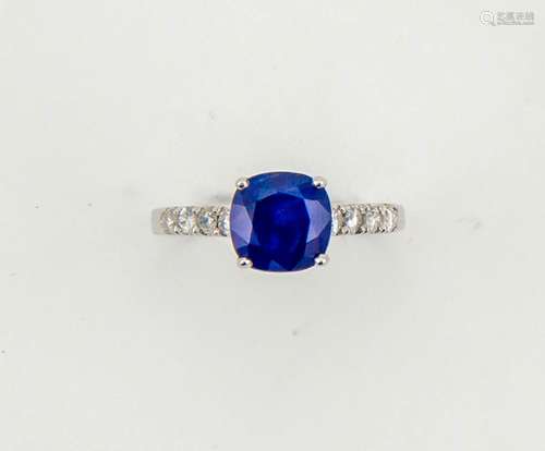 A 14ct white gold, sapphire and diamond ring, the cushion cut sapphire approx 2ct, set with