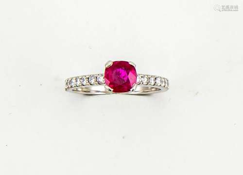 A platinum and ruby solitaire ring, set with diamonds to the shoulders, the ruby approx 0.90cts,