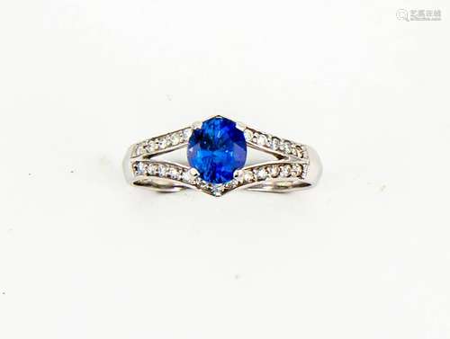 A 14ct white gold, sapphire and diamond ring, the oval sapphire approx 1.10ct, diamonds set in a