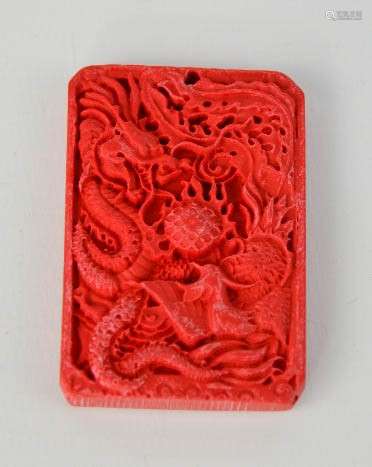 A Chinese carved cinnebar dragon pendant