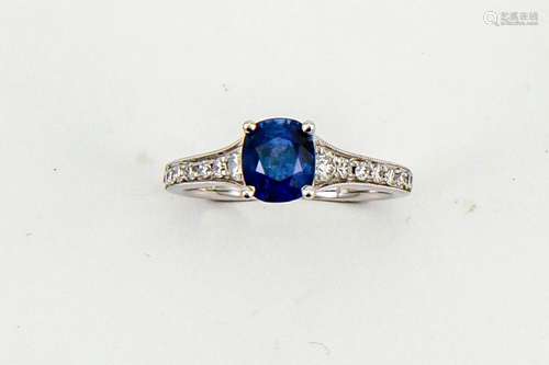 An 18ct white gold, sapphire and diamond ring, the cushion cut sapphire approx 1.60ct, with