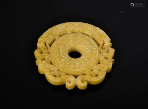 A Chinese natural pale yellow jade hand carved dragon pendant. 7.5cm wide