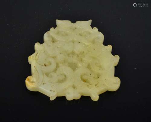 A Chinese hand carved natural jade dragon pendant. 7cm by 7.5cm