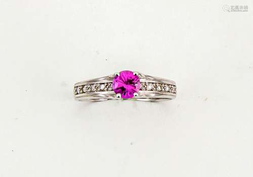 A 14ct white gold and pink sapphire solitaire ring, approx 0.5ct, the shoulders set with diamonds,