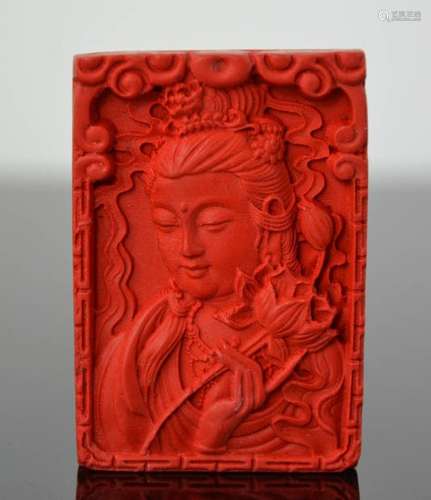 A Chinese finely carved organic cinnebar pendant of 'Guanyin'