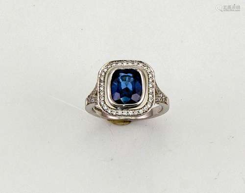 An 18ct white gold, sapphire and diamond ring, the cushion cut sapphire approximately 2.99ct, the