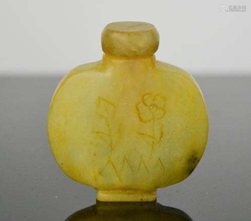 A Chinese hand carved natural jade snuff bottle, floral design, signed