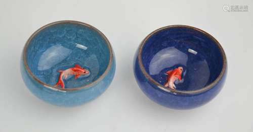 A pair of Chinese handcarved painted enamelled tea bowls with embossed goldfish to the centres.