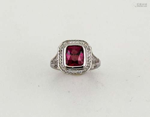 An 18ct white gold and rhodolite garnet and diamond ring, the cushion cut garnet approximately