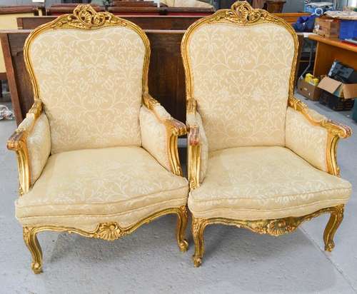 Two French giltwood 19th century style armchairs, with cream upholstery.