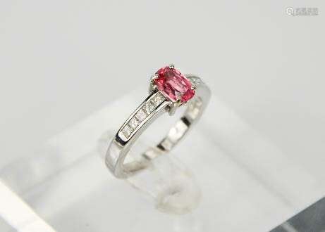 An 18ct white gold and oval pink spinel ring, approx 0.80ct, with princess cut diamonds to the